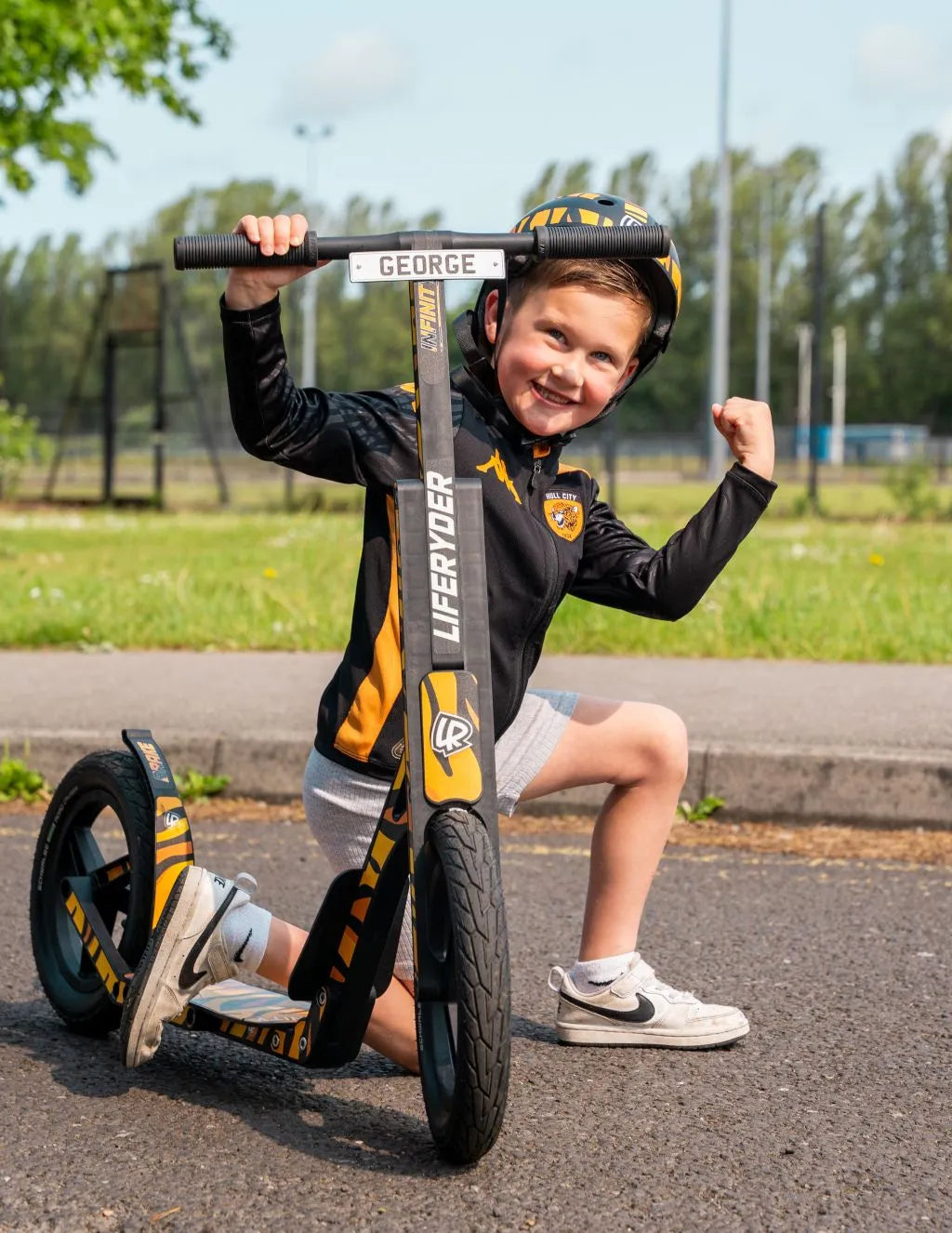 Child riding a LIFERYDER INFINITY big wheel scooter outdoors
