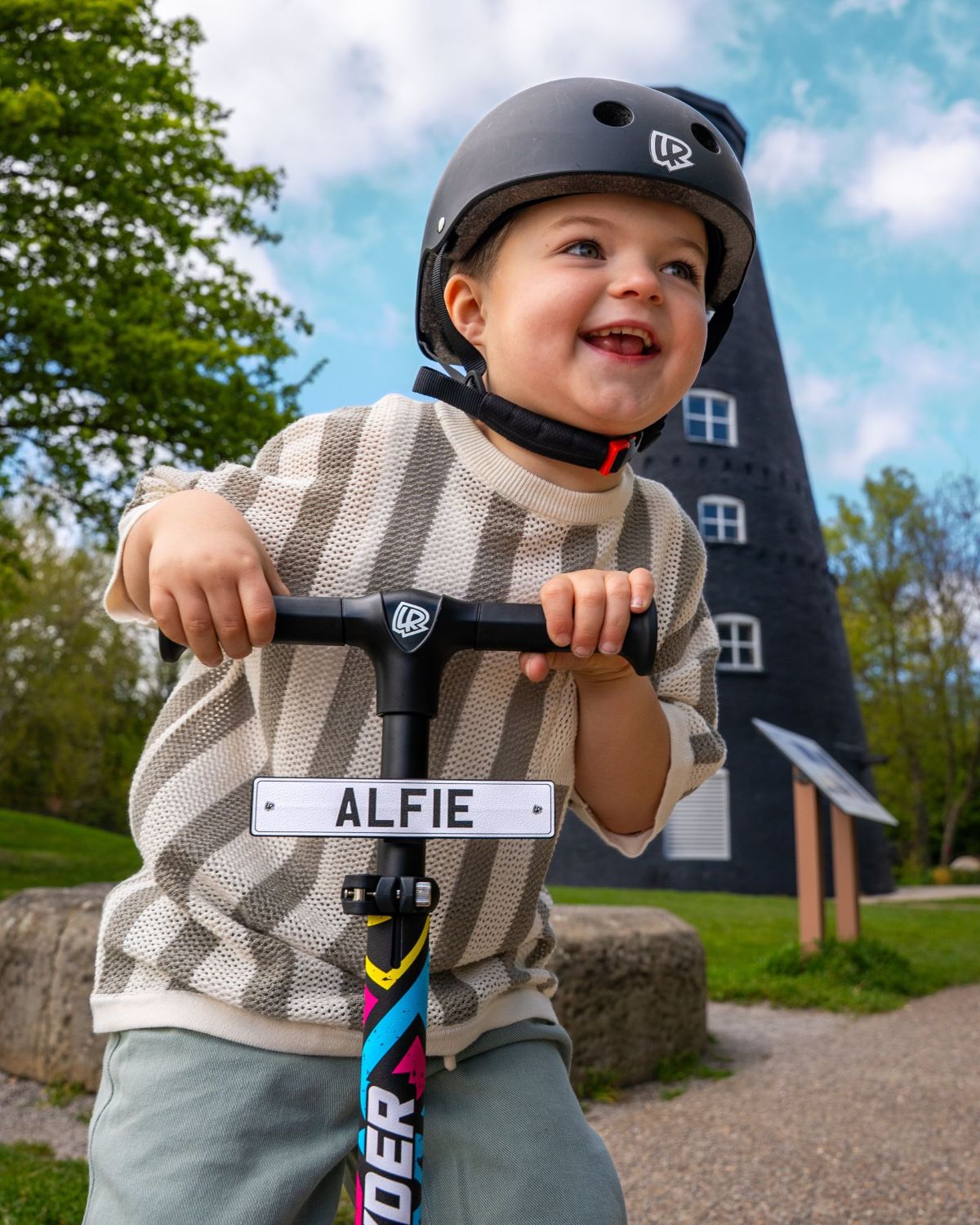 Child with a LIFERYDER HALO 3 wheel scooter and personalised mini reg plate