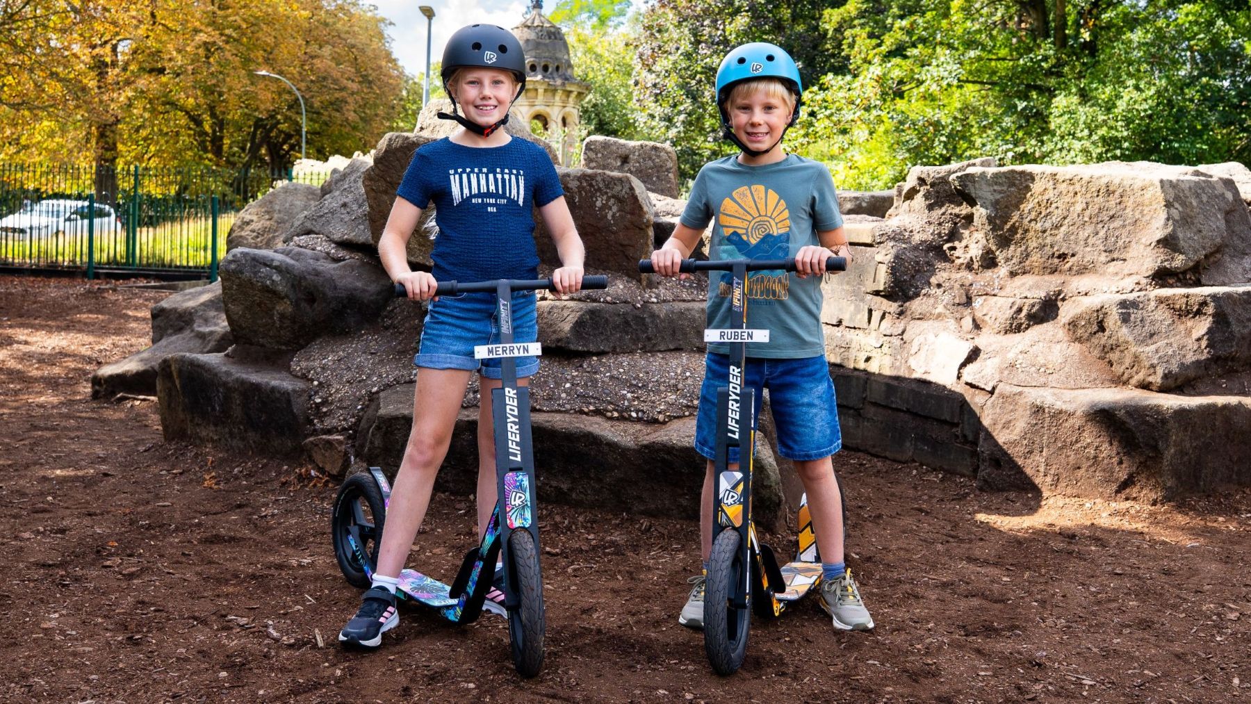 Children riding LIFERYDER INFINITY big wheel scooters in a park
