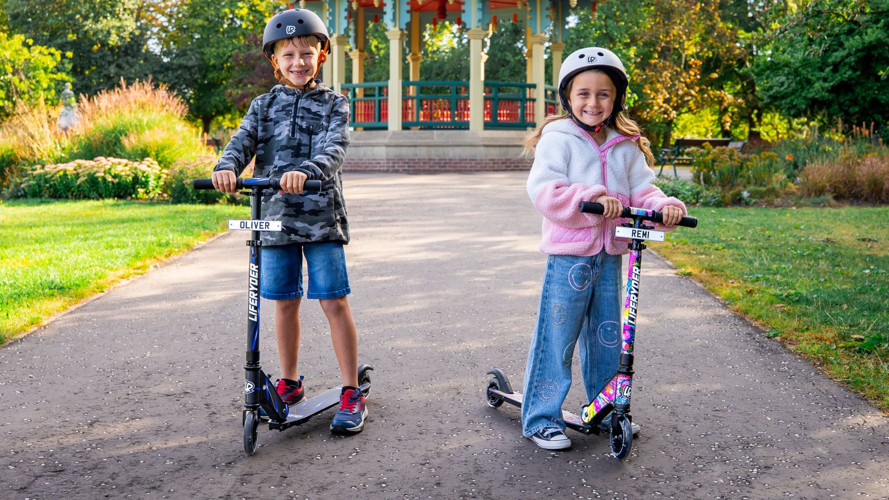 Children riding LIFERYDER QUEST 2 wheel scooters in a park