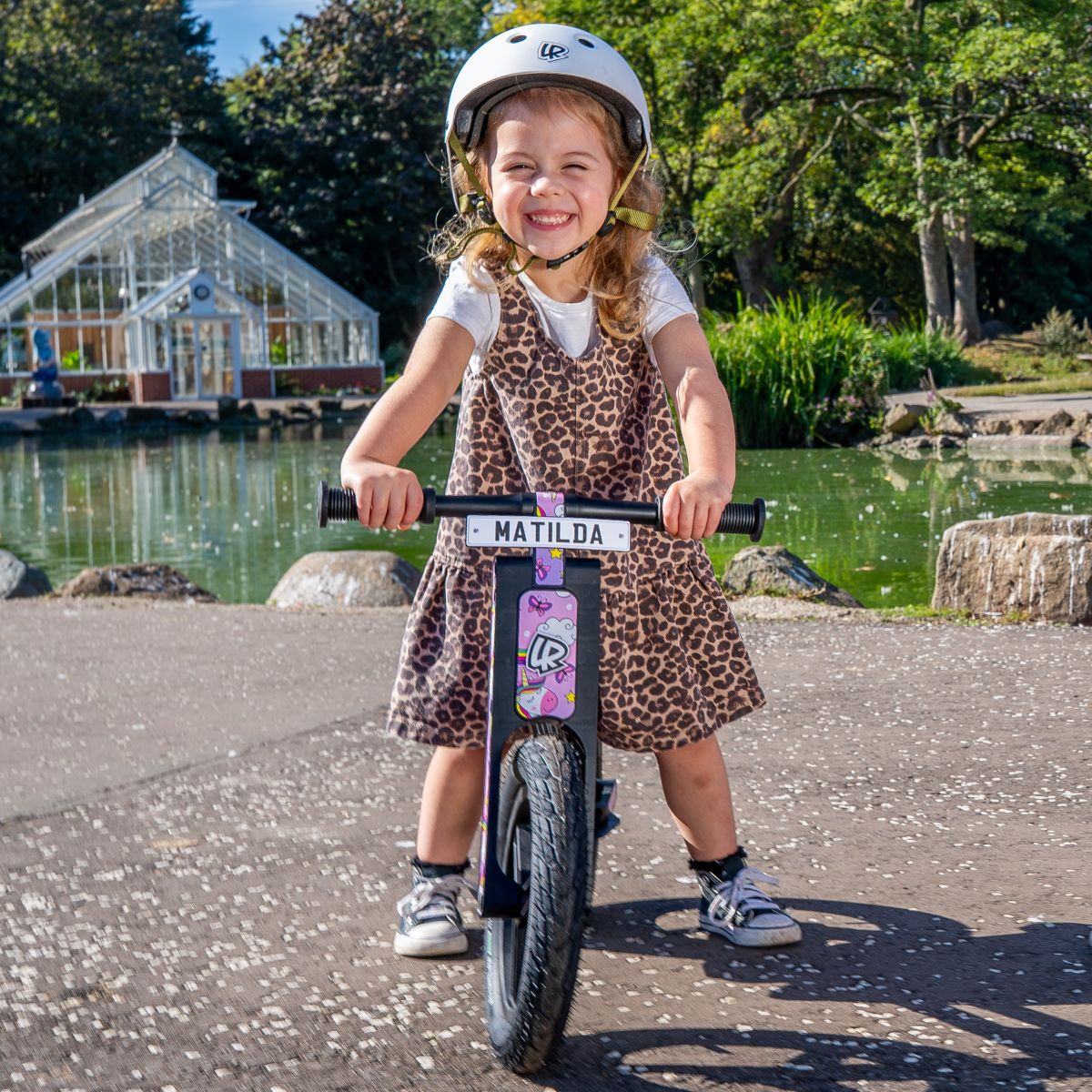 Girl riding a LIFERYDER VOGUE balance bike in a park