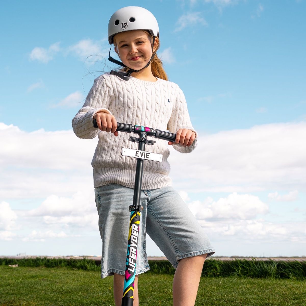 Child riding a LIFERYDER QUEST 2 wheel scooter with a personalised mini reg plate