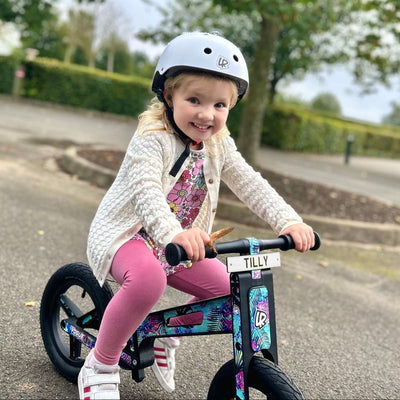 Child with a LIFERYDER VOGUE balance bike and personalised mini reg plate