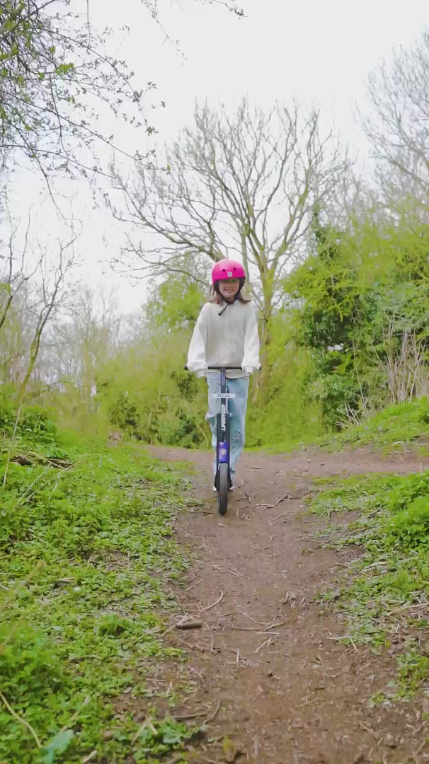 Load video: Child riding a LIFERYDER INFINITY big wheel scooter through woodland